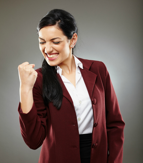 Happy hispanic businesswoman making a gesture of success